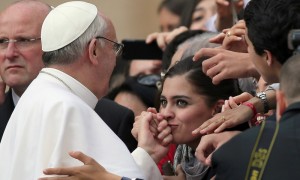 VATICAN CITY, VATICAN - MARCH 27:  A woman kisses the hand of Pope Francis as he greets the crowd around St Peter's Square after his first weekly general audience as pope on March 27, 2013 in Vatican City, Vatican. Pope Francis held his weekly general audience in St Peter's Square today  (Photo by Christopher Furlong/Getty Images)