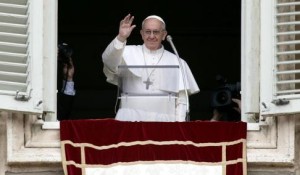 Newly elected Pope Francis appears at the window of his future private apartment to bless faithful during Angelus prayer at Vatican