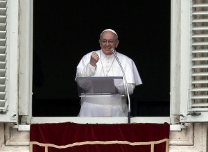 Newly elected Pope Francis appears at the window of his future private apartment to bless faithful during Angelus prayer at Vatican