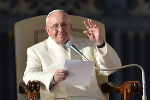 Pope Francis waves to the crowd during a general audience at St Peter's square on December 18, 2013 at the Vatican.  AFP PHOTO / ALBERTO PIZZOLI        (Photo credit should read ALBERTO PIZZOLI/AFP/Getty Images)